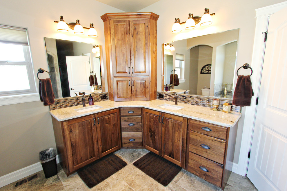 Photo of an expansive traditional master bathroom in Other with raised-panel cabinets, medium wood cabinets, a hot tub, a shower/bathtub combo, a two-piece toilet, brown tile, glass sheet wall, beige walls, ceramic floors, an undermount sink, granite benchtops, beige floor and an open shower.