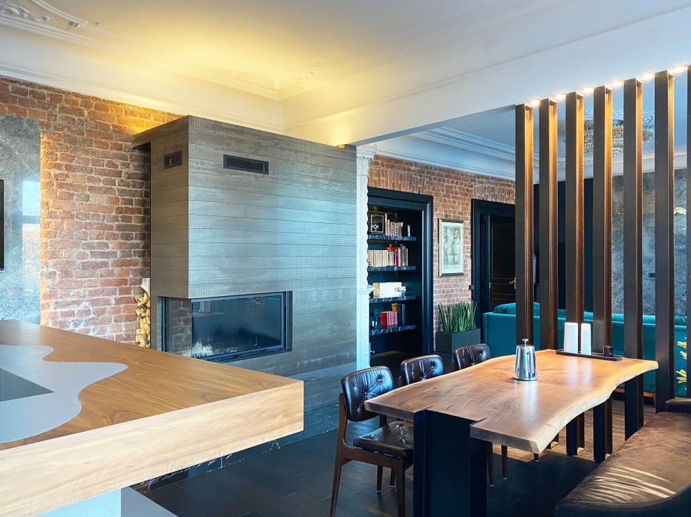 Design ideas for an expansive industrial kitchen/dining room in Saint Petersburg with black walls, dark hardwood flooring, a corner fireplace, a tiled fireplace surround, exposed beams and brick walls.