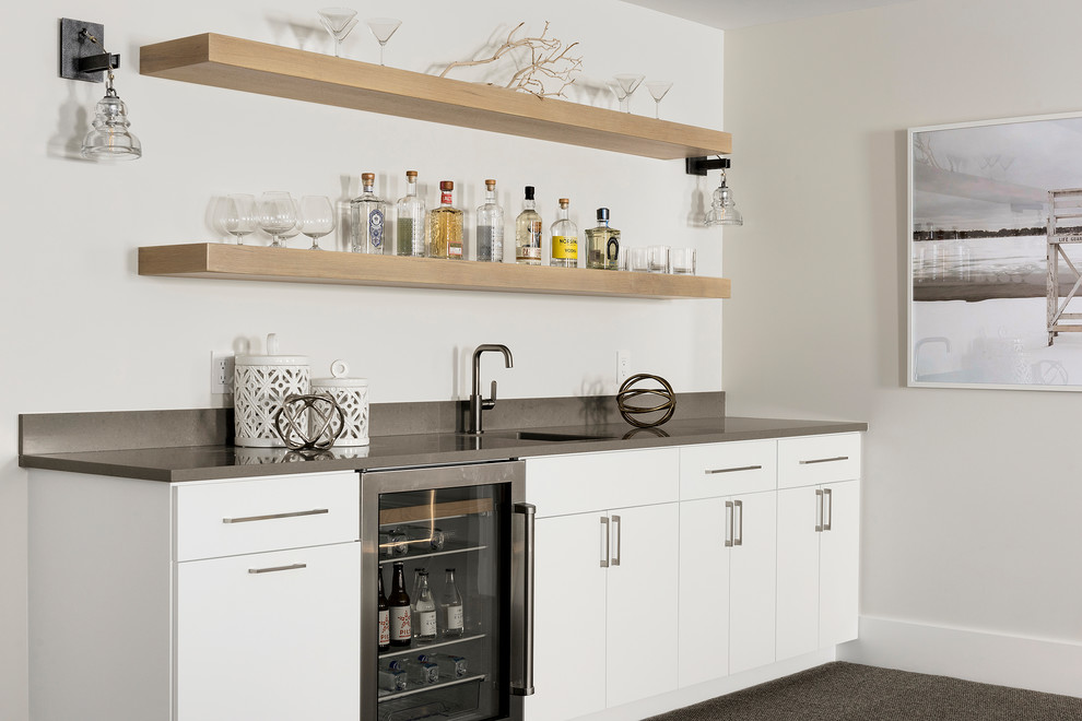 Inspiration for a contemporary single-wall wet bar in Minneapolis with an undermount sink, flat-panel cabinets, white cabinets, grey floor and grey benchtop.