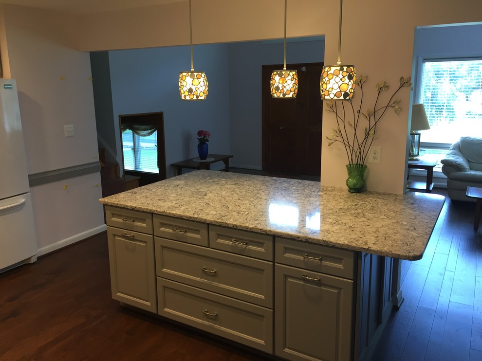 Large elegant l-shaped dark wood floor open concept kitchen photo in Baltimore with raised-panel cabinets, gray cabinets, granite countertops, an island, an undermount sink, multicolored backsplash, porcelain backsplash and white appliances