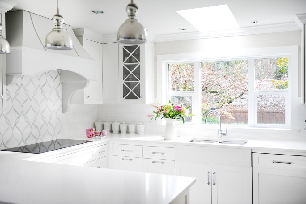 Inspiration for a large transitional u-shaped vinyl floor eat-in kitchen remodel in Vancouver with an undermount sink, shaker cabinets, white cabinets, quartz countertops, white backsplash, stone tile backsplash, paneled appliances and a peninsula