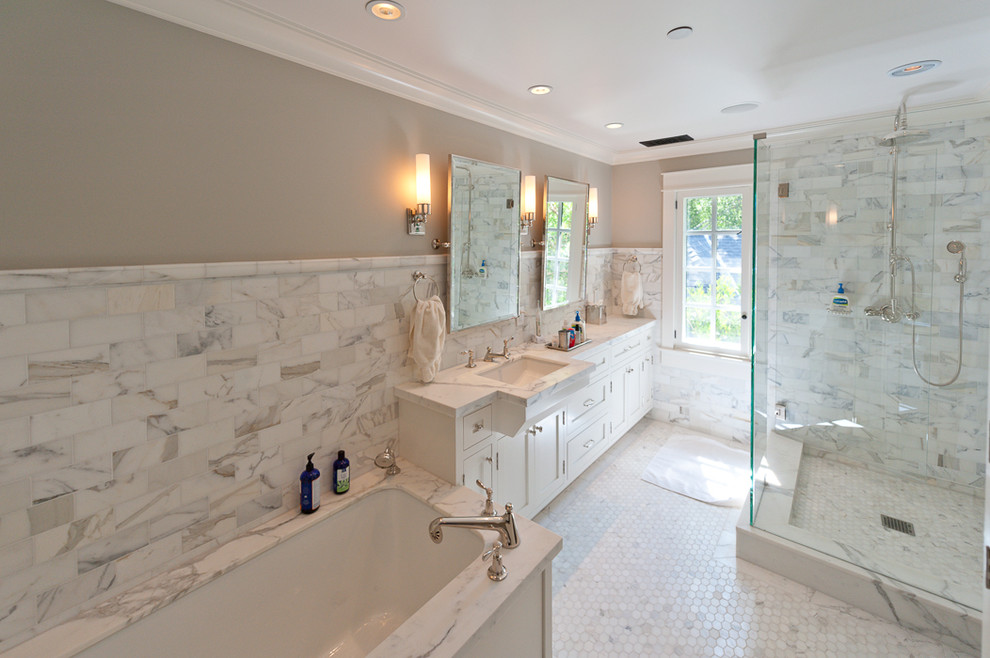 Inspiration for a large transitional master bathroom in San Francisco with shaker cabinets, white cabinets, an undermount tub, a corner shower, gray tile, white tile, marble, beige walls, marble floors, an undermount sink, marble benchtops, white floor and a hinged shower door.