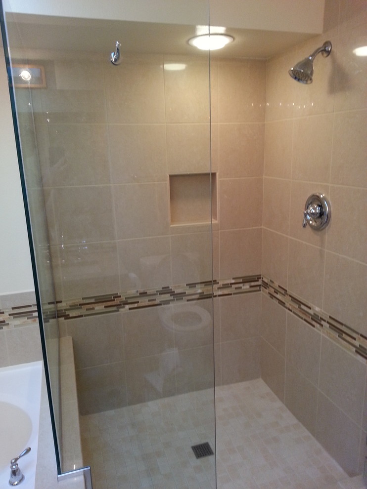Design ideas for a mid-sized modern master bathroom in Seattle with an undermount sink, engineered quartz benchtops, a corner shower, a two-piece toilet, beige tile, glass tile, beige walls and porcelain floors.