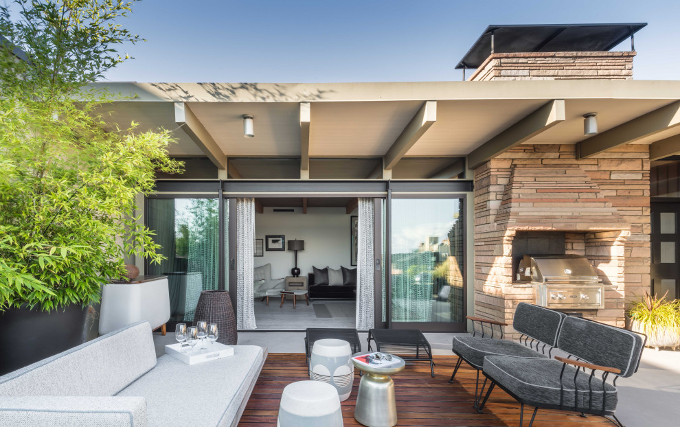 Photo of a midcentury rooftop deck in Seattle with a container garden and a roof extension.