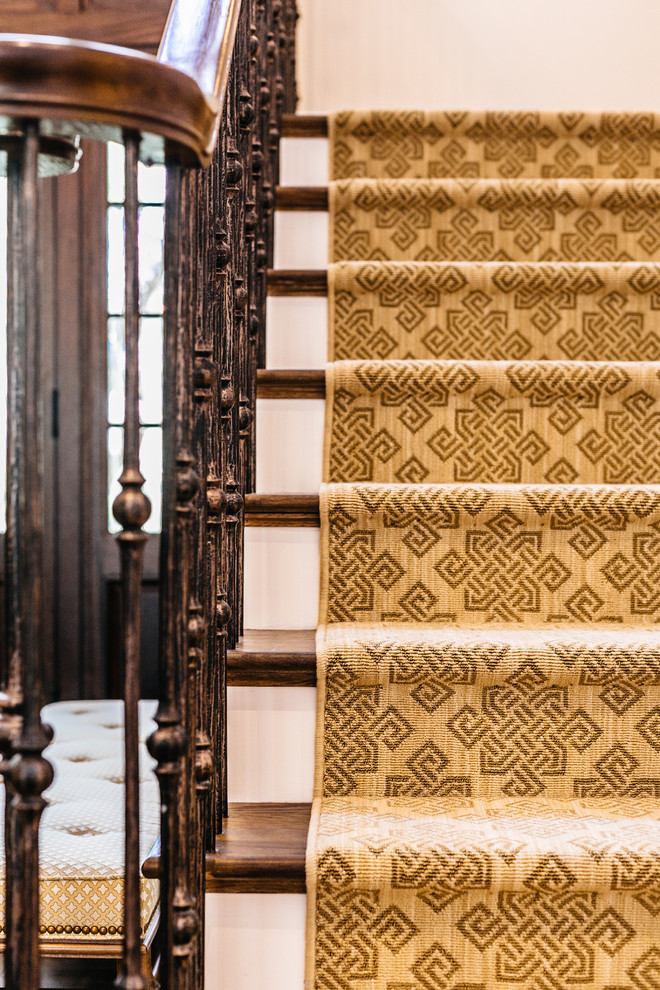 This is an example of a large transitional carpeted u-shaped staircase in Charleston with carpet risers and mixed railing.