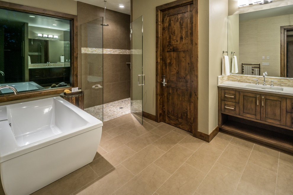 Photo of a large asian master bathroom in Other with beaded inset cabinets, medium wood cabinets, a curbless shower, an undermount sink, granite benchtops and a freestanding tub.