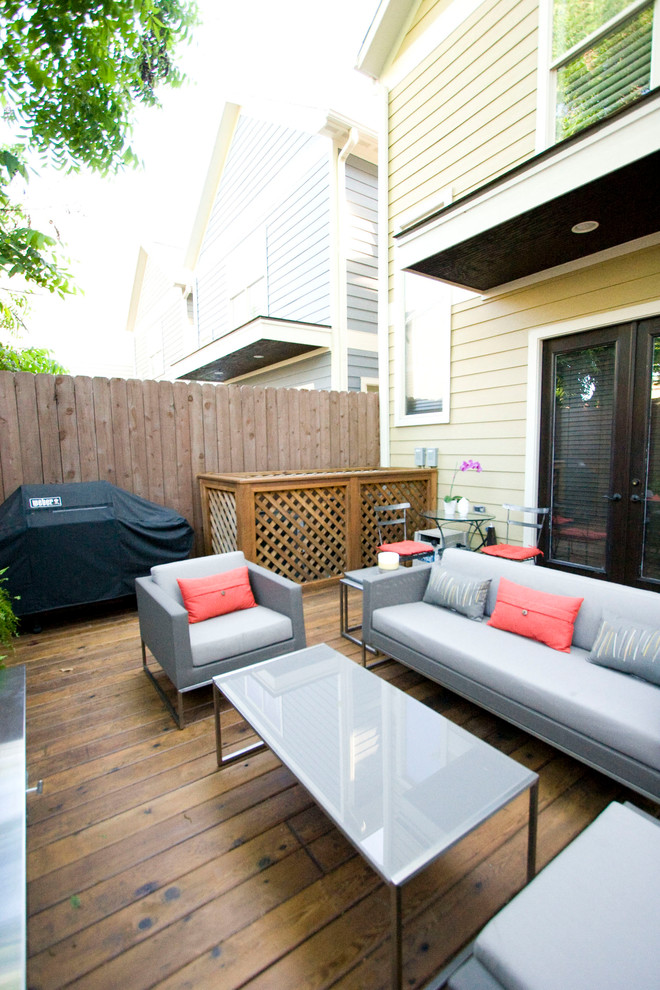 Design ideas for a small eclectic backyard patio in Houston with a fire feature, decking and no cover.