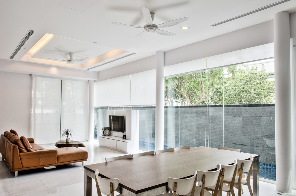 Photo of a large contemporary dining room in Singapore with white walls and marble floors.