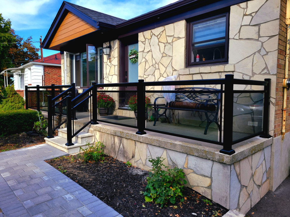 This is an example of a transitional verandah in Toronto with glass railing.