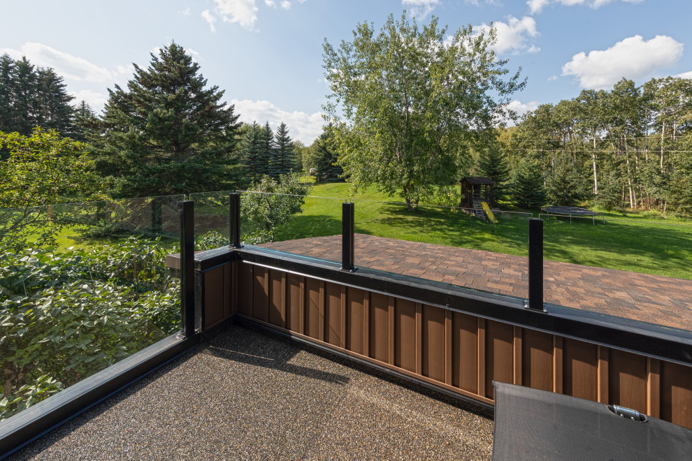Photo of a small rustic glass railing balcony in Edmonton with no cover.