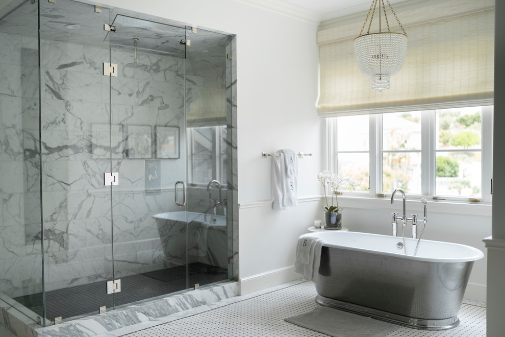 Inspiration for an expansive transitional master bathroom in Los Angeles with a freestanding tub, a double shower, a one-piece toilet, white tile, white walls, mosaic tile floors, a drop-in sink, marble benchtops, white floor, a hinged shower door, brown cabinets, marble and white benchtops.