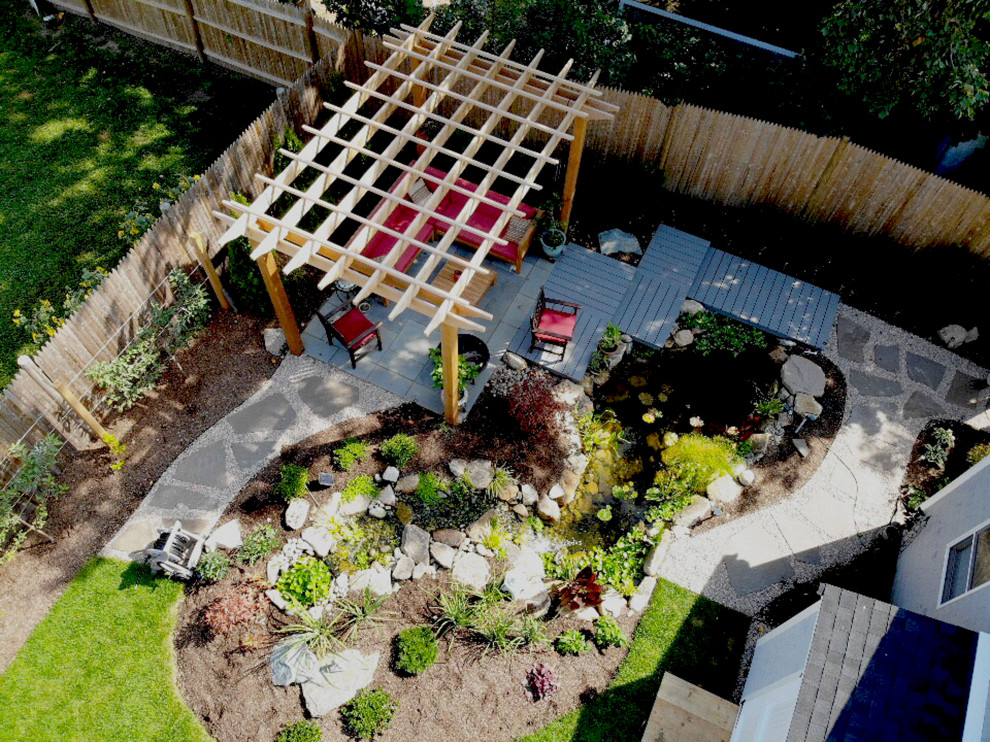 Photo of a small asian backyard partial sun garden for summer in Providence with with pond and decking.