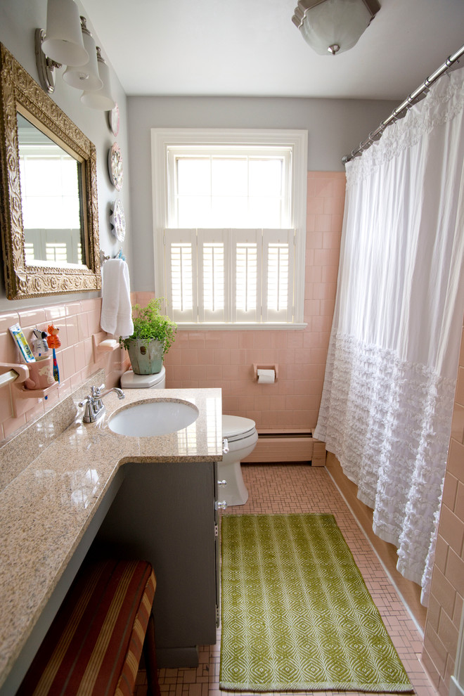 Small eclectic bathroom in Other with an undermount sink, grey cabinets, granite benchtops, an alcove tub, pink tile, ceramic tile, grey walls, ceramic floors, a shower/bathtub combo and a shower curtain.