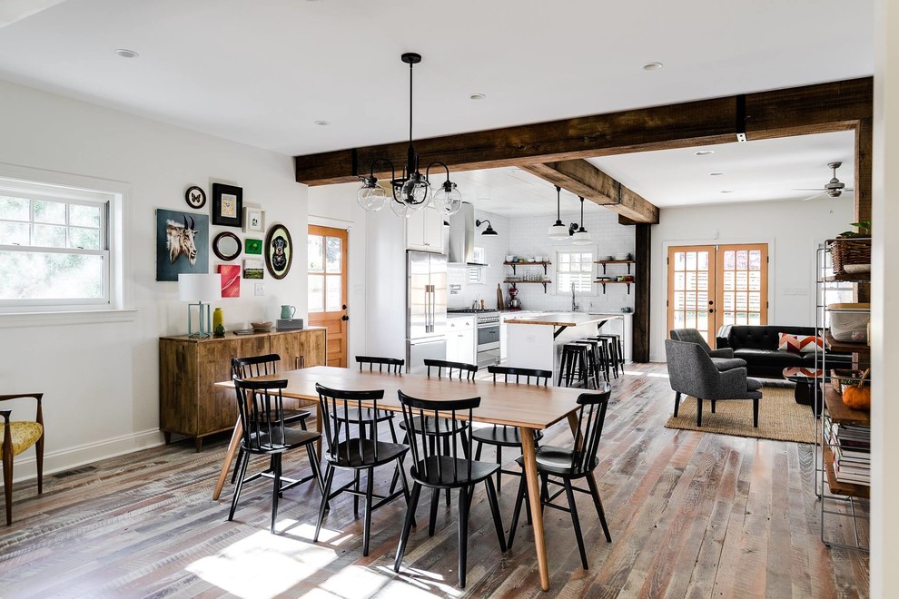 This is an example of a transitional open plan dining in Richmond with white walls.