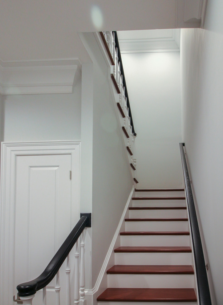 Example of a large transitional wooden floating wood railing staircase design in DC Metro with wooden risers