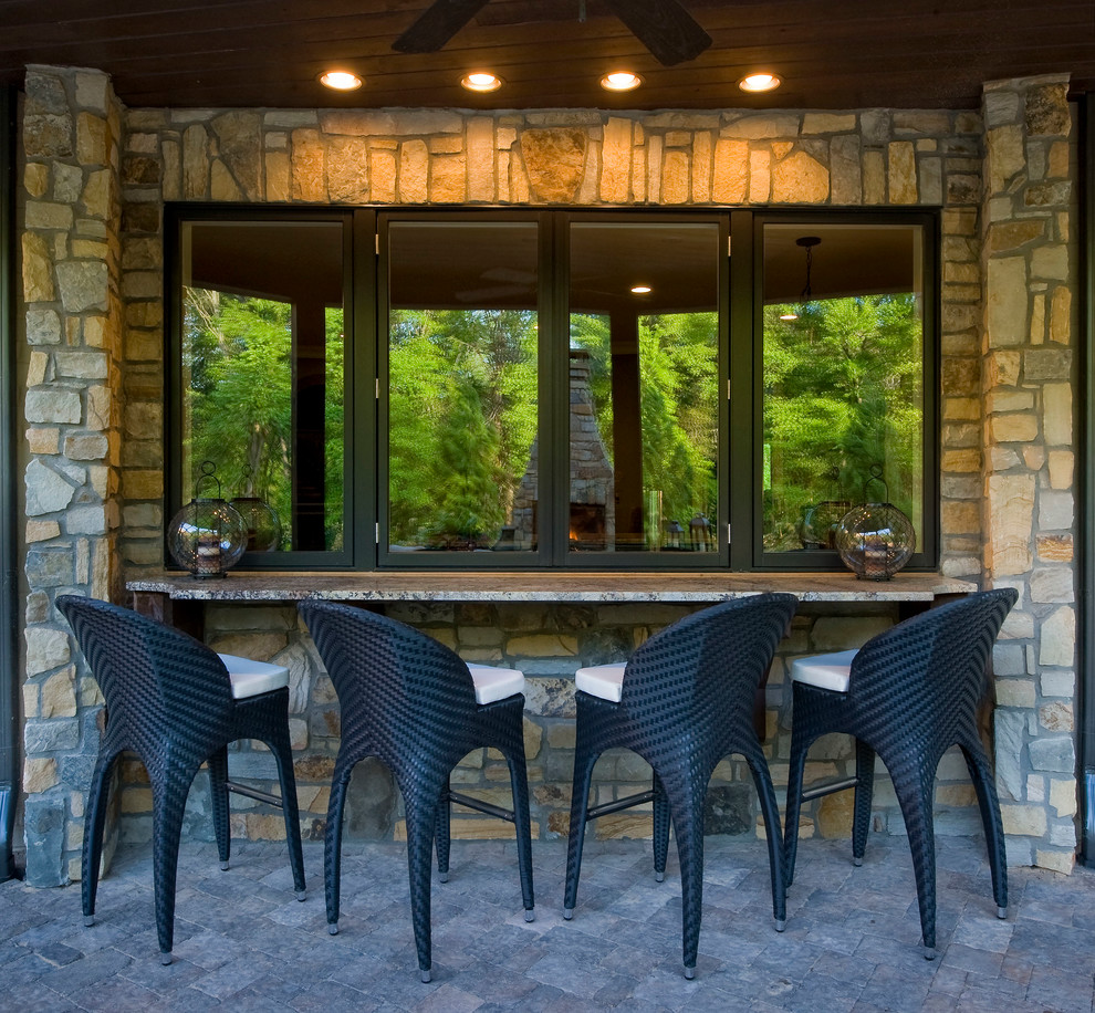 Design ideas for an eclectic patio in Charlotte with a roof extension.