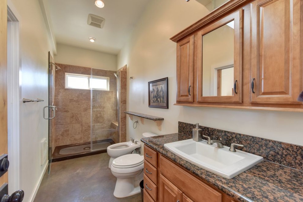 Expansive transitional 3/4 bathroom in Sacramento with raised-panel cabinets, light wood cabinets, an alcove shower, a two-piece toilet, beige walls, concrete floors, a drop-in sink, grey floor and a hinged shower door.
