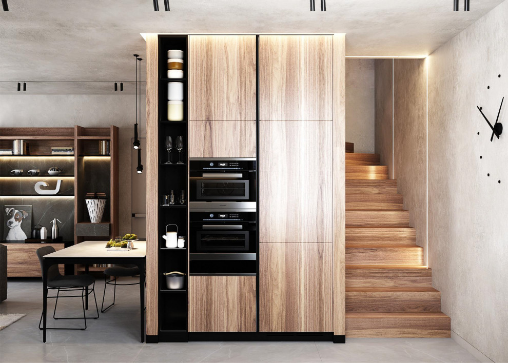Open concept kitchen - small modern galley ceramic tile and gray floor open concept kitchen idea with flat-panel cabinets, light wood cabinets, black appliances and no island