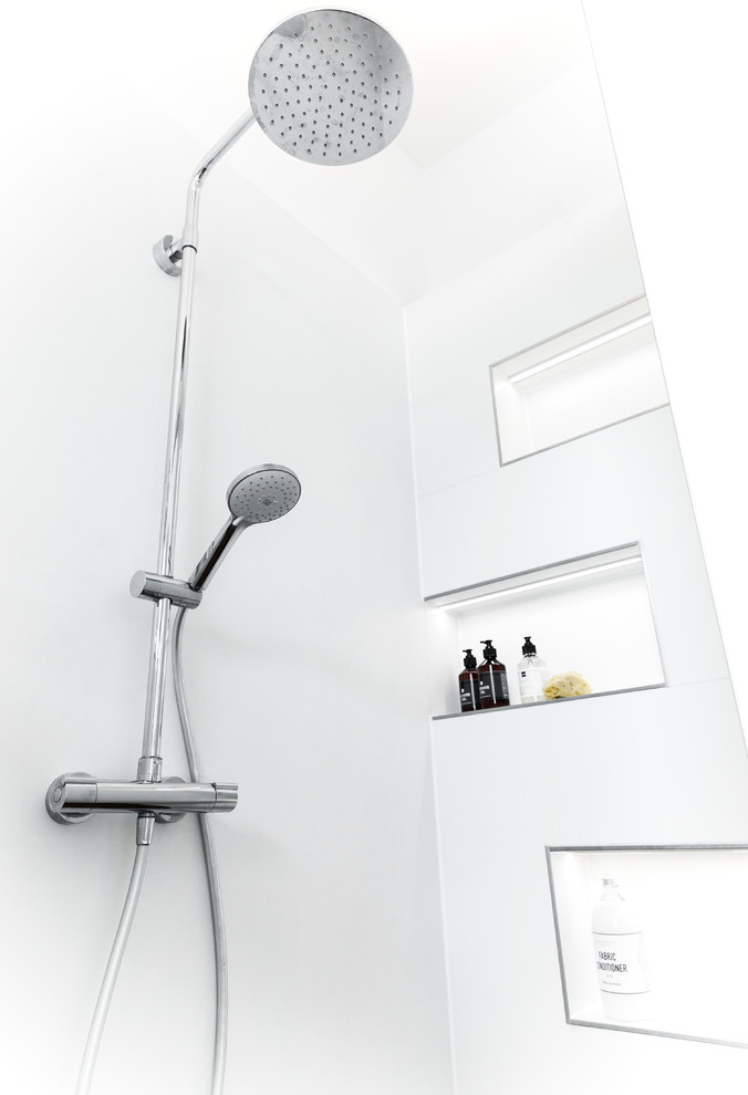 Design ideas for a large industrial master bathroom in Frankfurt with flat-panel cabinets, grey cabinets, a freestanding tub, a curbless shower, a wall-mount toilet, white walls, medium hardwood floors, a vessel sink, solid surface benchtops, brown floor, a sliding shower screen and grey benchtops.