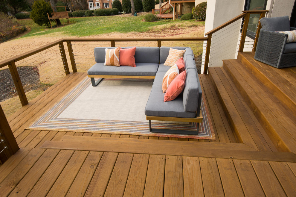This is an example of a large contemporary back wire cable railing terrace in Atlanta.