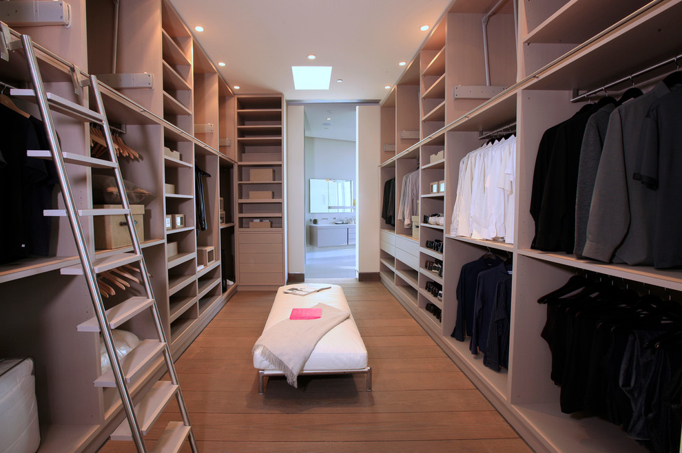 This is an example of a contemporary men's dressing room in Los Angeles with open cabinets and light wood cabinets.
