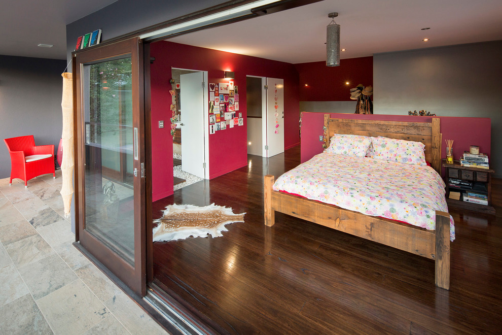 Mid-sized contemporary master bedroom in Sydney with pink walls and medium hardwood floors.
