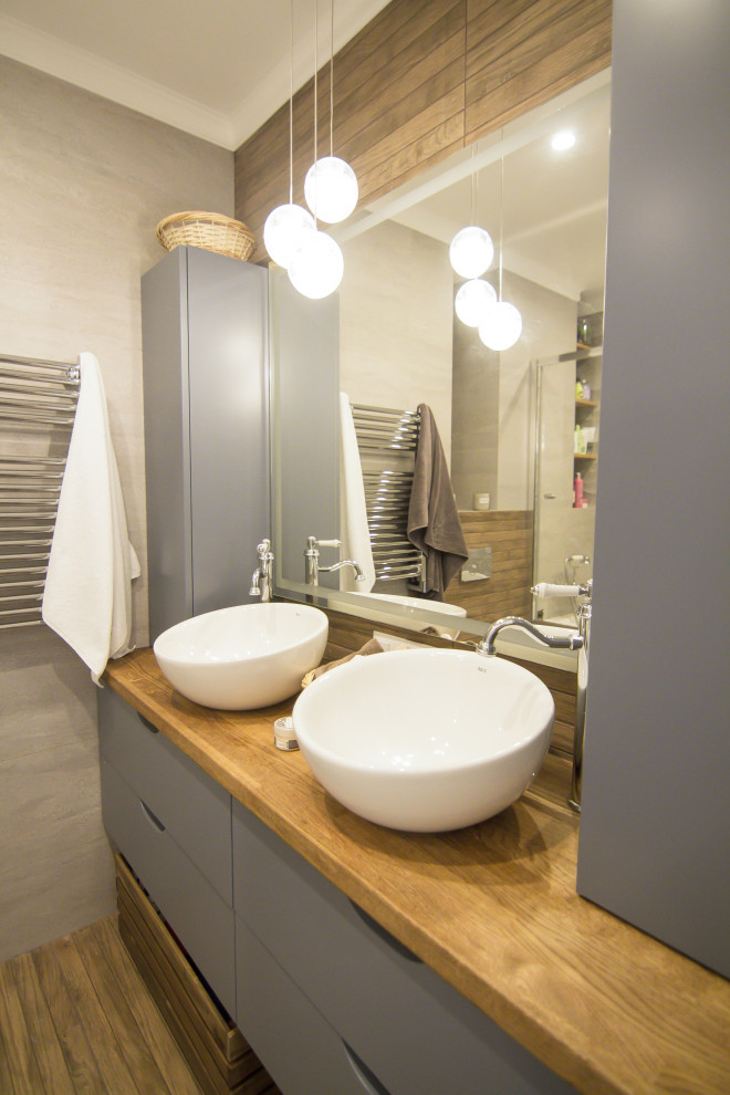 Photo of a small scandinavian bathroom in Moscow with flat-panel cabinets, wood benchtops and a double vanity.