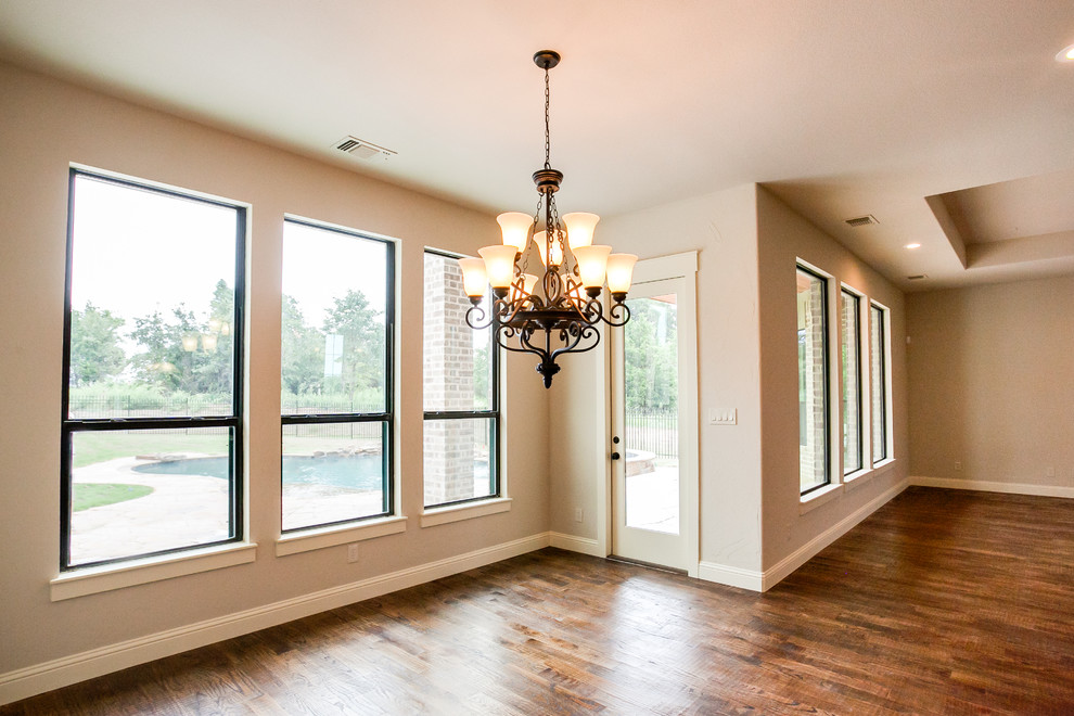 Mid-sized traditional open plan dining in Dallas with beige walls, dark hardwood floors and brown floor.