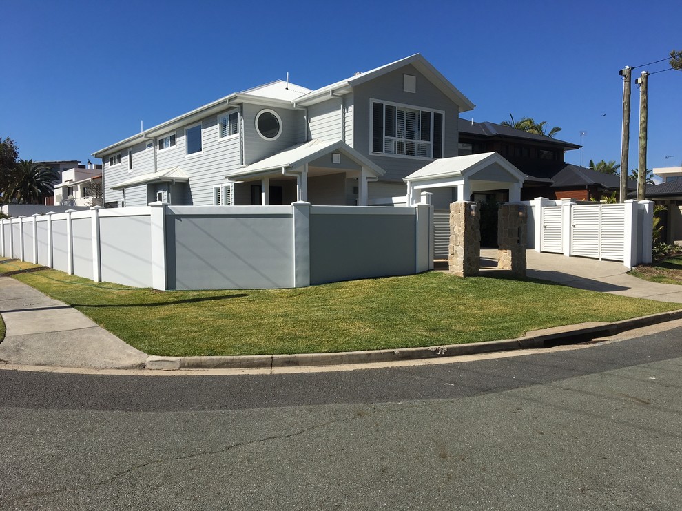 Mid-sized traditional two-storey concrete beige house exterior in Gold Coast - Tweed with a gambrel roof and a shingle roof.