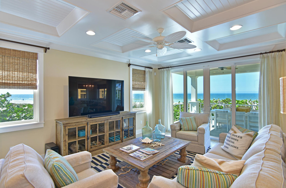 This is an example of a large beach style enclosed living room in Tampa with beige walls, light hardwood floors, no fireplace and no tv.