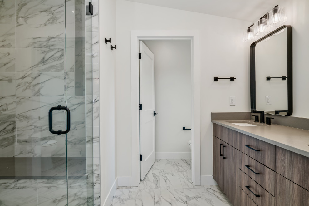 This is an example of a mid-sized contemporary master bathroom in Denver with flat-panel cabinets, brown cabinets, engineered quartz benchtops, a double vanity and a built-in vanity.