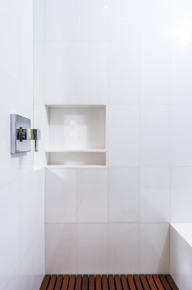 This is an example of a large midcentury master bathroom in Los Angeles with flat-panel cabinets, medium wood cabinets, a corner shower, a one-piece toilet, white tile, stone tile, white walls, marble floors, an undermount sink and engineered quartz benchtops.