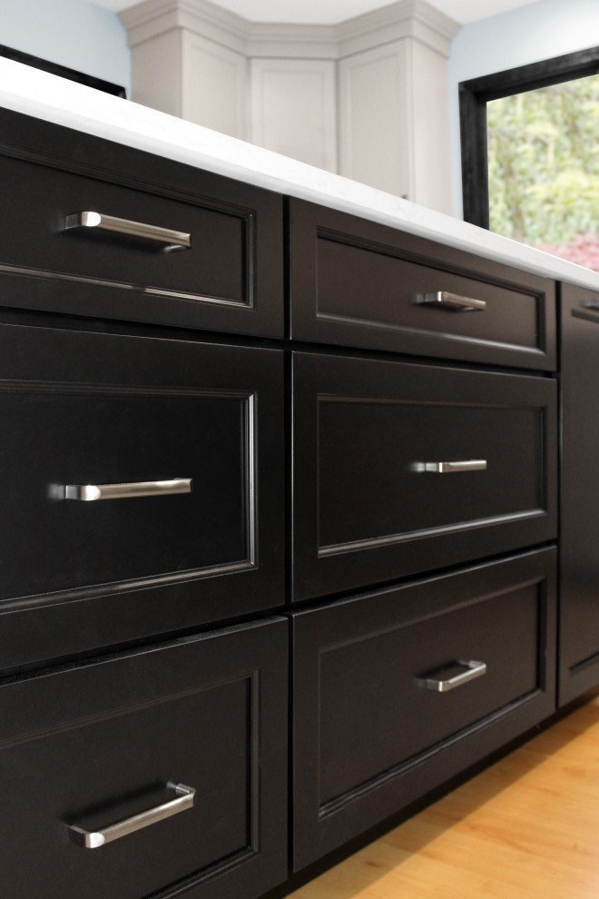 Example of a large transitional u-shaped light wood floor and brown floor closet design in Boston with a double-bowl sink, shaker cabinets, gray cabinets, quartz countertops, white backsplash, porcelain backsplash, black appliances, an island and white countertops