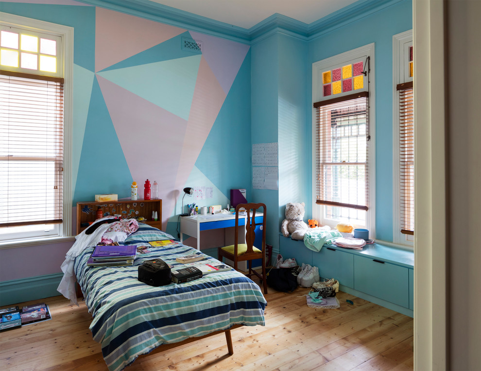 Photo of a mid-sized contemporary kids' room for girls in Melbourne with multi-coloured walls and medium hardwood floors.