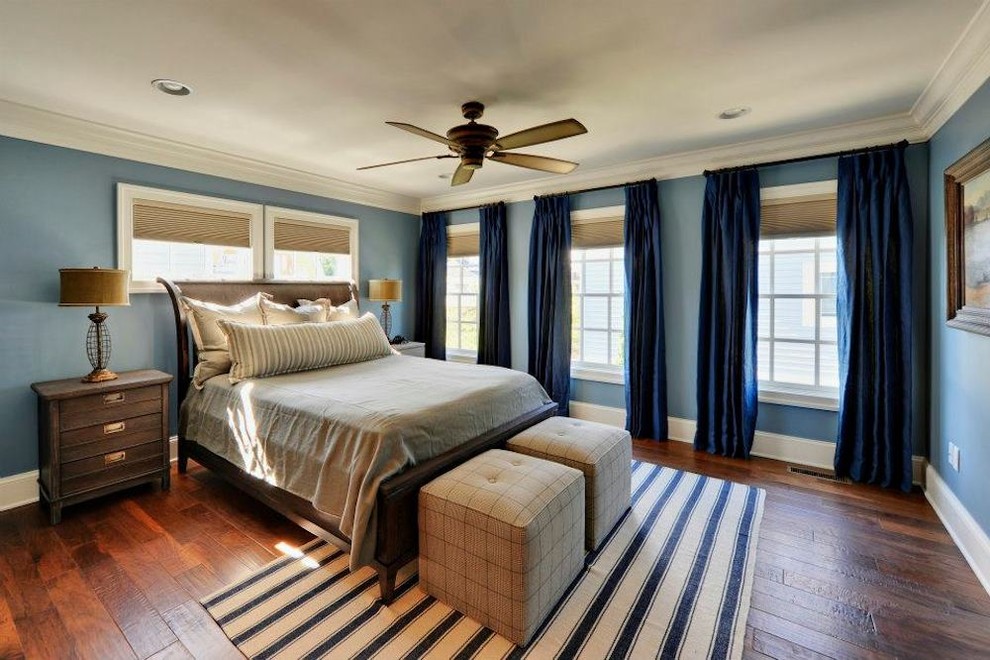 Bedroom - master medium tone wood floor bedroom idea in Charlotte with blue walls and no fireplace