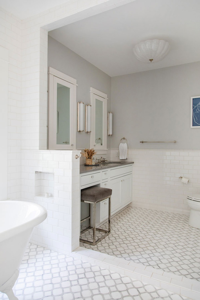Bathroom - large craftsman master white tile and porcelain tile porcelain tile, white floor and single-sink bathroom idea in Other with shaker cabinets, white cabinets, a two-piece toilet, white walls, an undermount sink, gray countertops, a built-in vanity and solid surface countertops