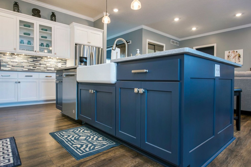 Example of a mid-sized transitional single-wall dark wood floor and brown floor enclosed kitchen design in Columbus with a farmhouse sink, shaker cabinets, white cabinets, granite countertops, multicolored backsplash, matchstick tile backsplash, stainless steel appliances, an island and gray countertops