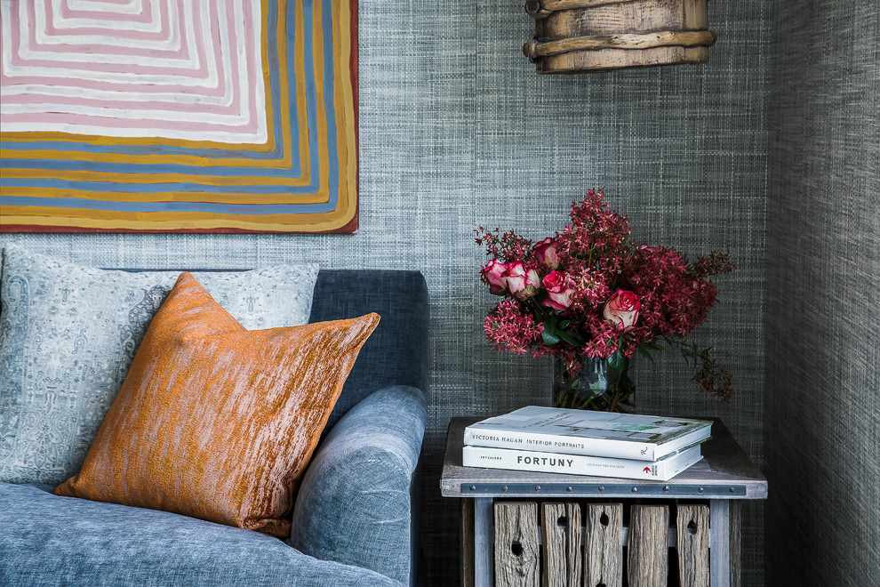 Photo of an eclectic open concept living room in Sydney with grey walls and light hardwood floors.