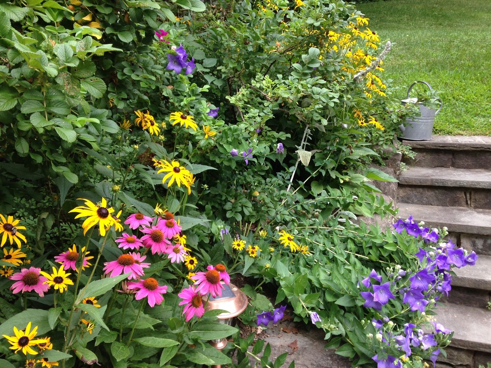 Design ideas for a traditional sloped garden for summer in New York.