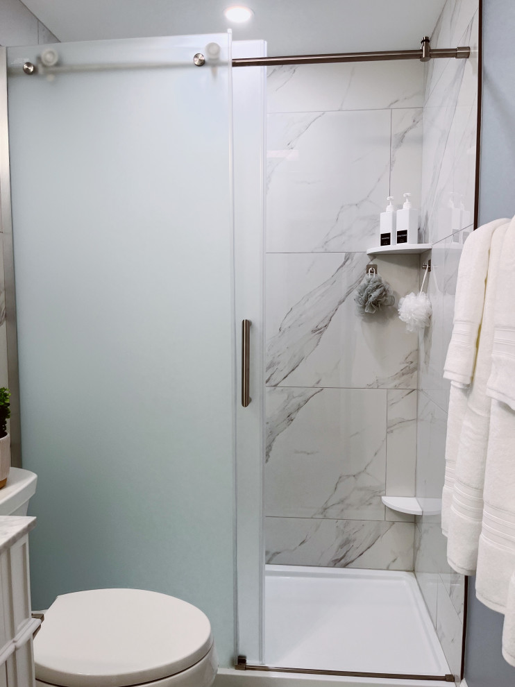 Inspiration for a small transitional kids' white tile and porcelain tile porcelain tile, white floor and single-sink alcove shower remodel with shaker cabinets, white cabinets, a two-piece toilet, blue walls, an undermount sink, marble countertops, gray countertops and a freestanding vanity