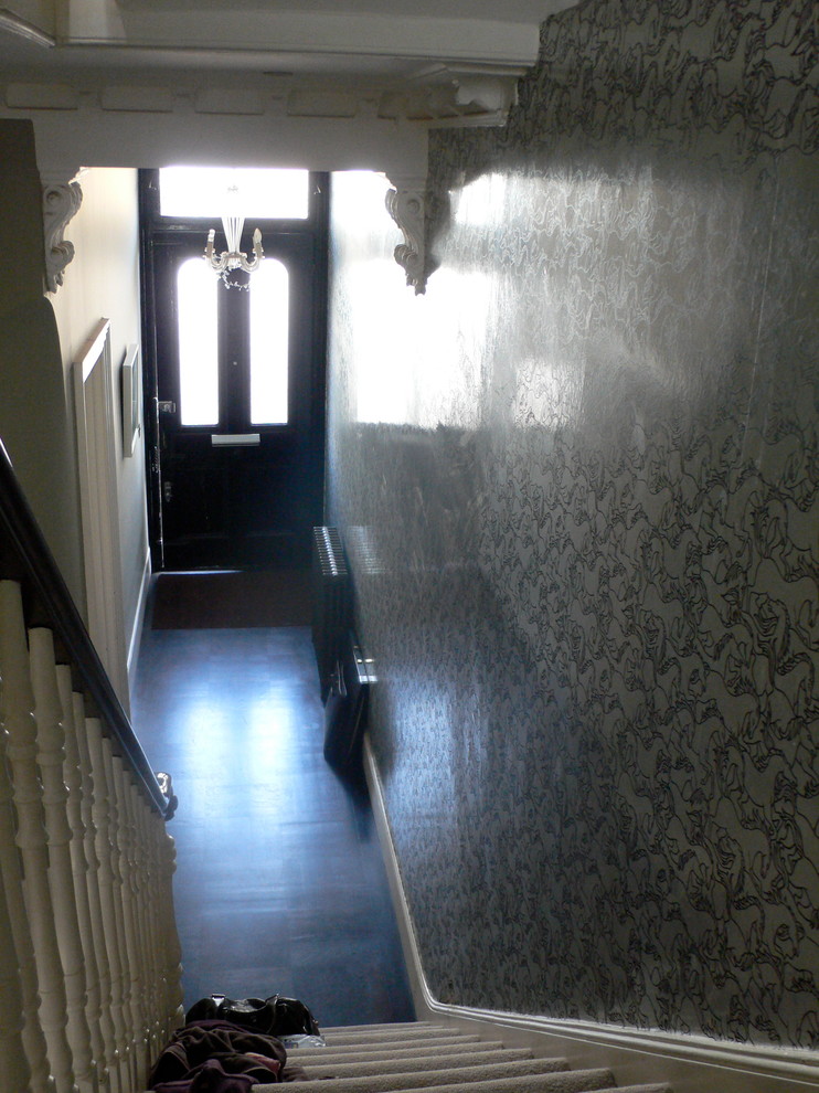 Photo of a traditional hallway in London with grey walls and dark hardwood floors.