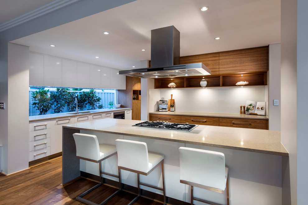 This is an example of a contemporary kitchen in Perth with flat-panel cabinets, medium wood cabinets, medium hardwood floors and a peninsula.