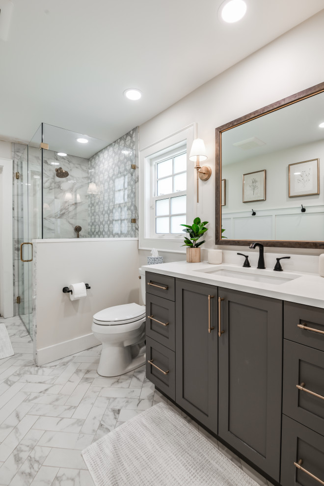 Medium sized traditional shower room bathroom in Tampa with recessed-panel cabinets, dark wood cabinets, a double shower, grey tiles, marble tiles, marble flooring, a submerged sink, engineered stone worktops, a hinged door, white worktops, a single sink, a built in vanity unit and wainscoting.