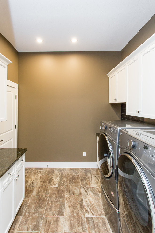 Design ideas for a mid-sized country galley dedicated laundry room in Calgary with an undermount sink, shaker cabinets, white cabinets, granite benchtops, brown walls, ceramic floors, a side-by-side washer and dryer, brown floor and green benchtop.