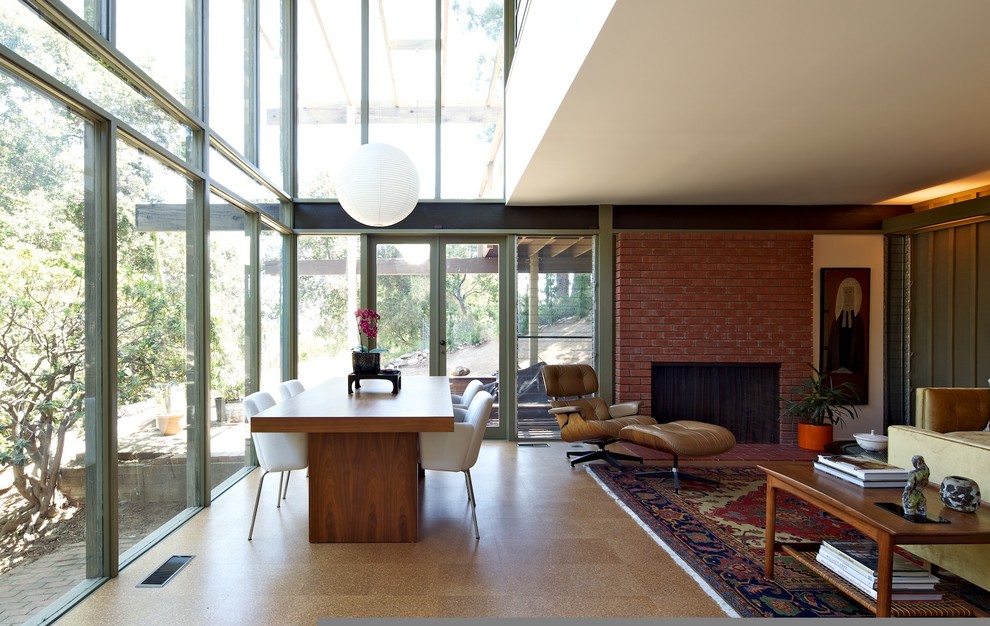 Inspiration for a midcentury dining room in Los Angeles with a brick fireplace surround and medium hardwood floors.