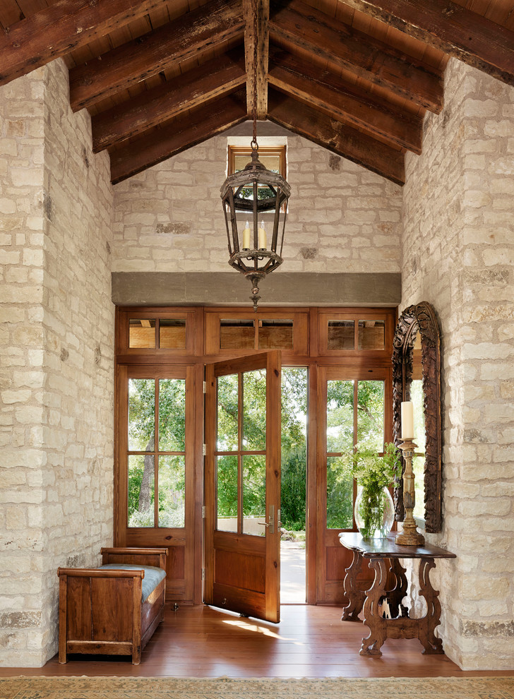 Mediterranean entryway in Austin with medium hardwood floors, a single front door and a medium wood front door.