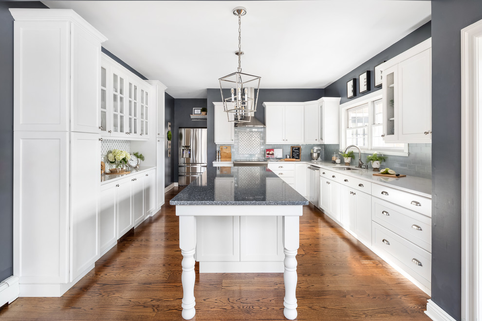 Inspiration for a huge transitional l-shaped dark wood floor and brown floor eat-in kitchen remodel in Philadelphia with a single-bowl sink, flat-panel cabinets, white cabinets, quartzite countertops, gray backsplash, ceramic backsplash, stainless steel appliances, an island and white countertops