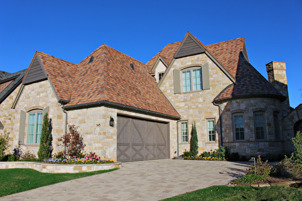 Inspiration for a two-storey exterior in Dallas with stone veneer and a hip roof.
