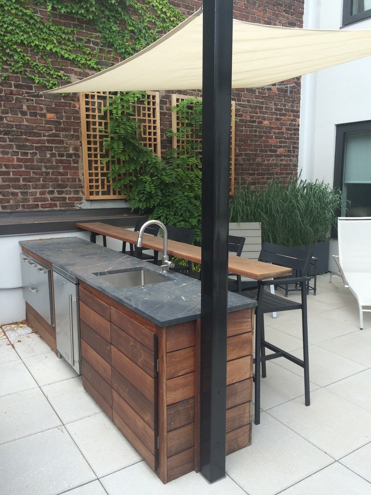 Design ideas for a mid-sized contemporary courtyard patio in New York with no cover, tile and an outdoor kitchen.