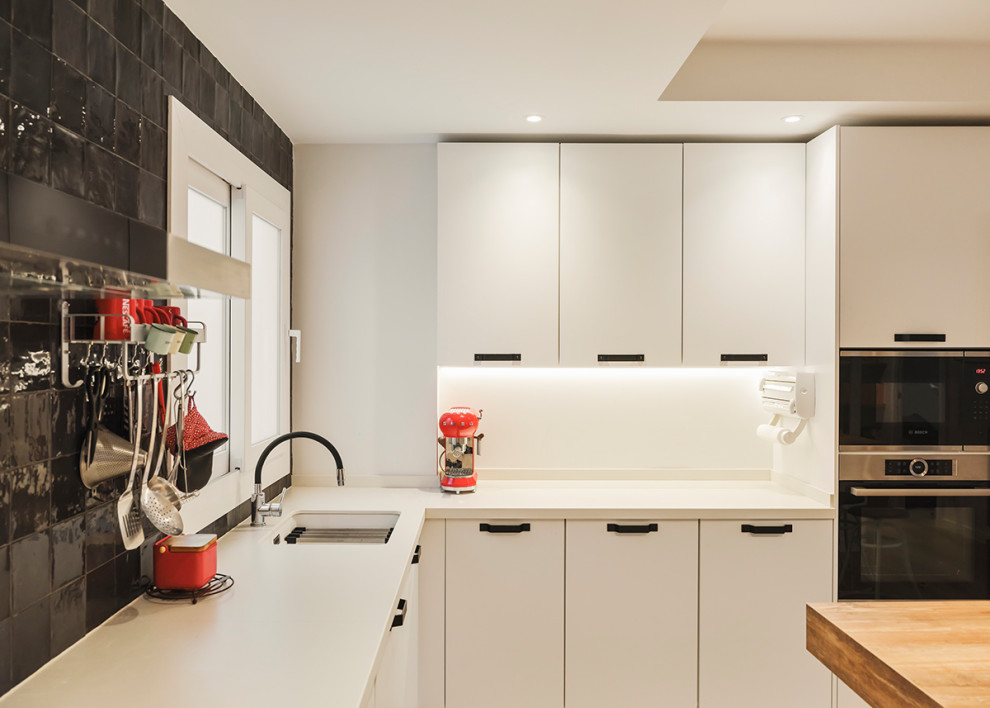 Mid-sized scandinavian single-wall eat-in kitchen in Other with a single-bowl sink, shaker cabinets, white cabinets, quartz benchtops, white splashback, ceramic splashback, panelled appliances, medium hardwood floors, no island, brown floor and white benchtop.
